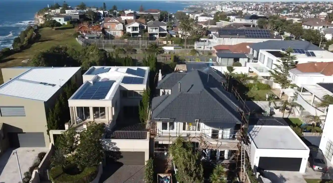 Professional Prisma Coatings team applying protective coating to residential property exterior