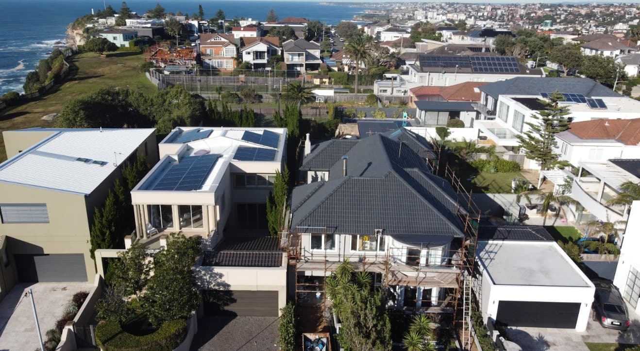 Professional Prisma Coatings team applying protective coating to residential property exterior